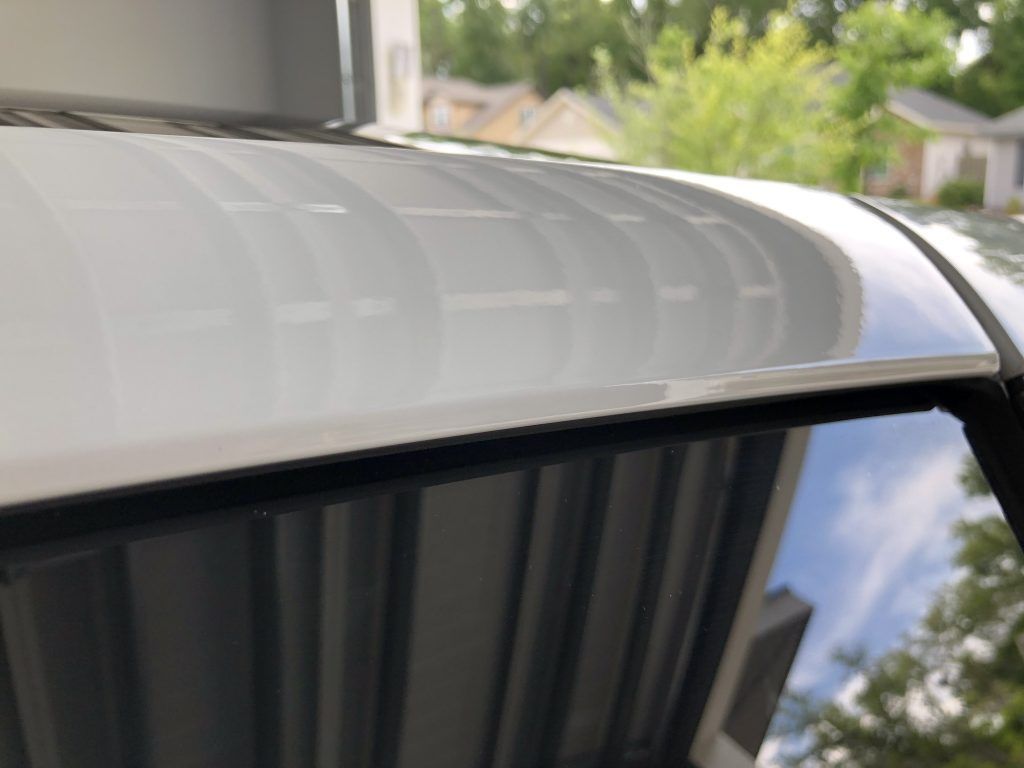 A close up of the roof of a car in a garage.