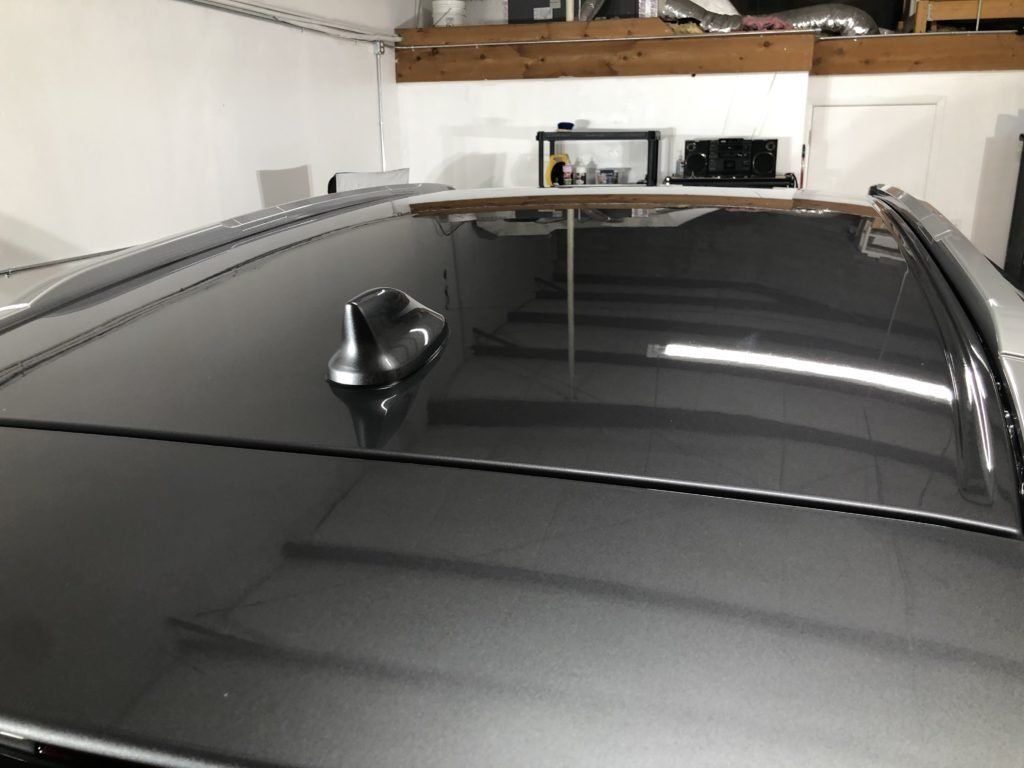 A close up of a car 's roof in a garage.