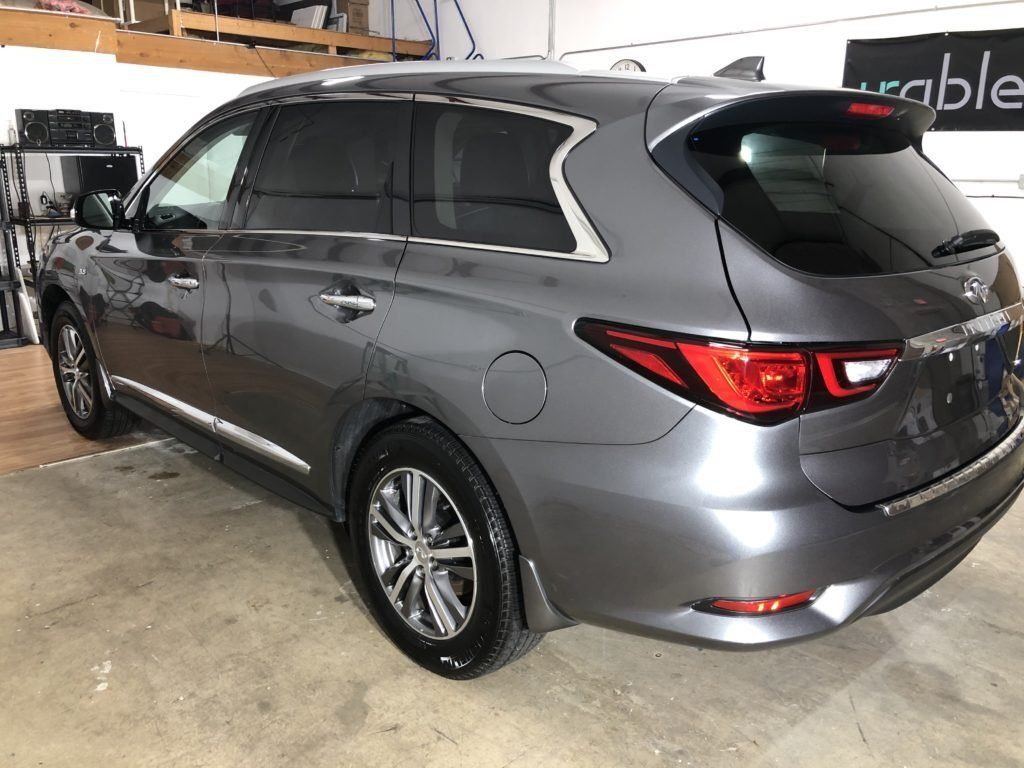 A gray suv is parked in a garage.