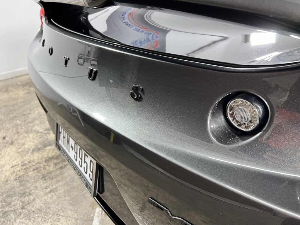 A close up of the back of a gray car.