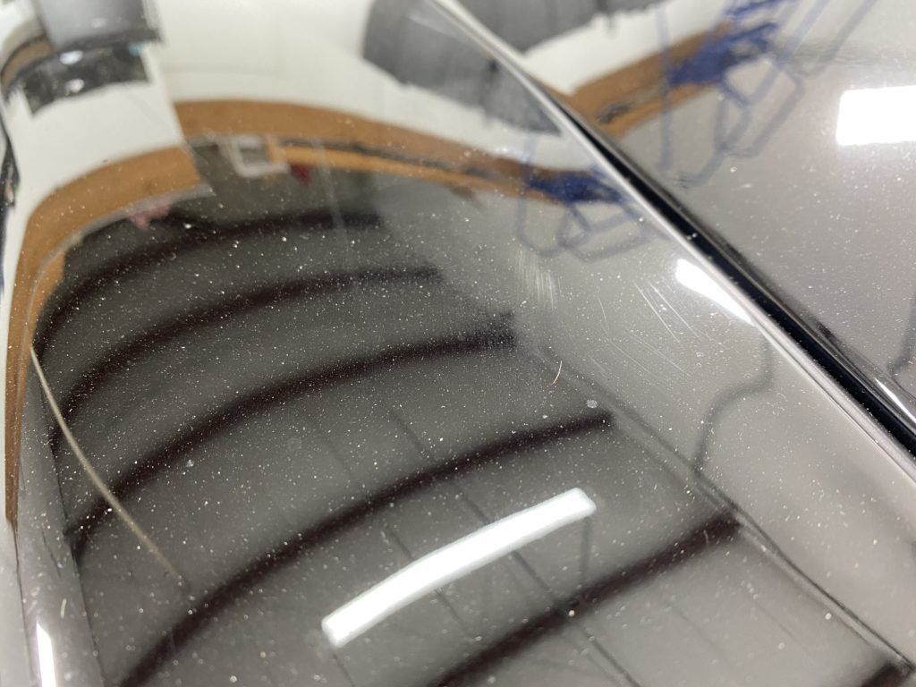 A close up of a car hood with a lot of dust on it