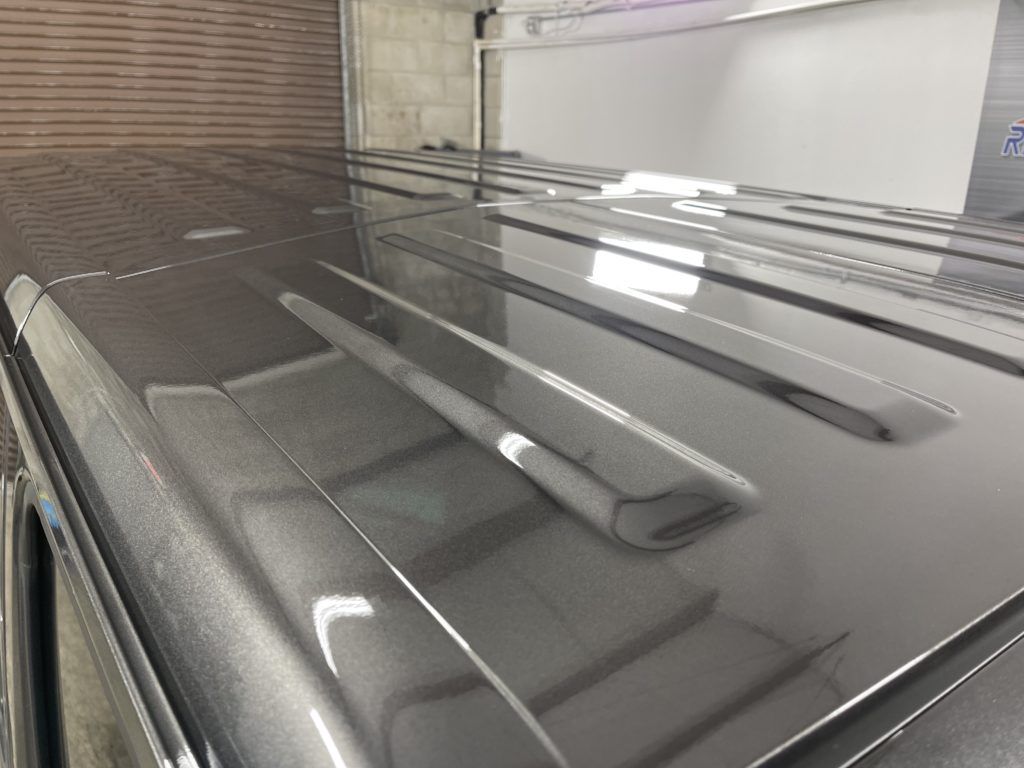 A close up of the roof of a car in a garage.