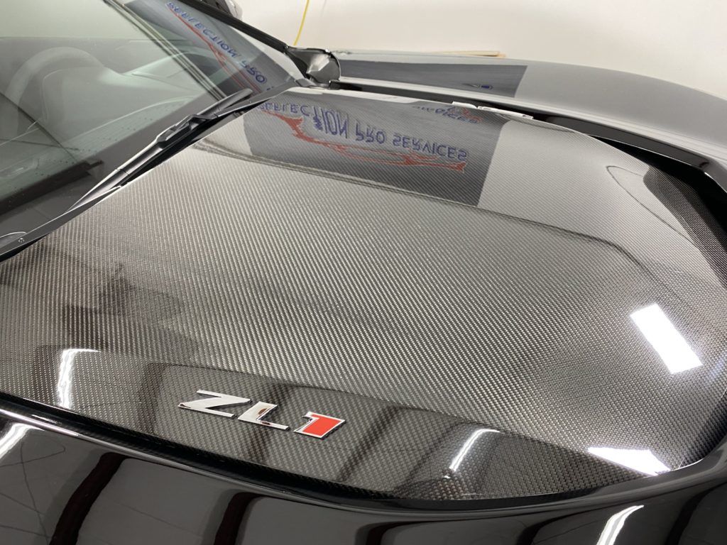 A close up of the hood of a black car.