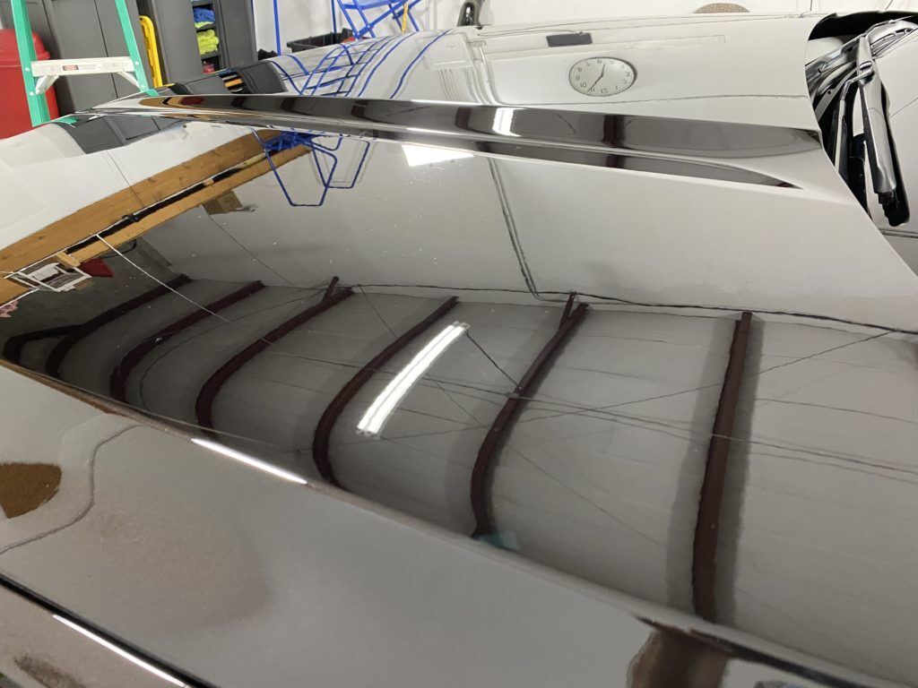 A close up of a car 's roof in a garage.
