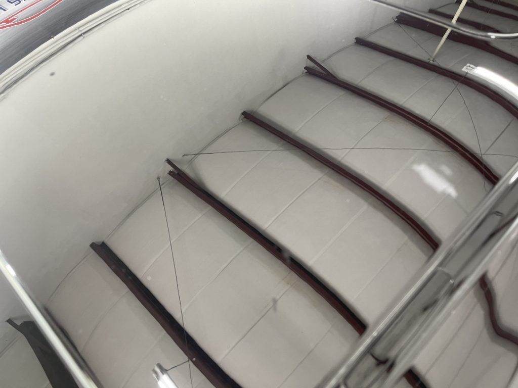 A set of curved stairs with a metal railing