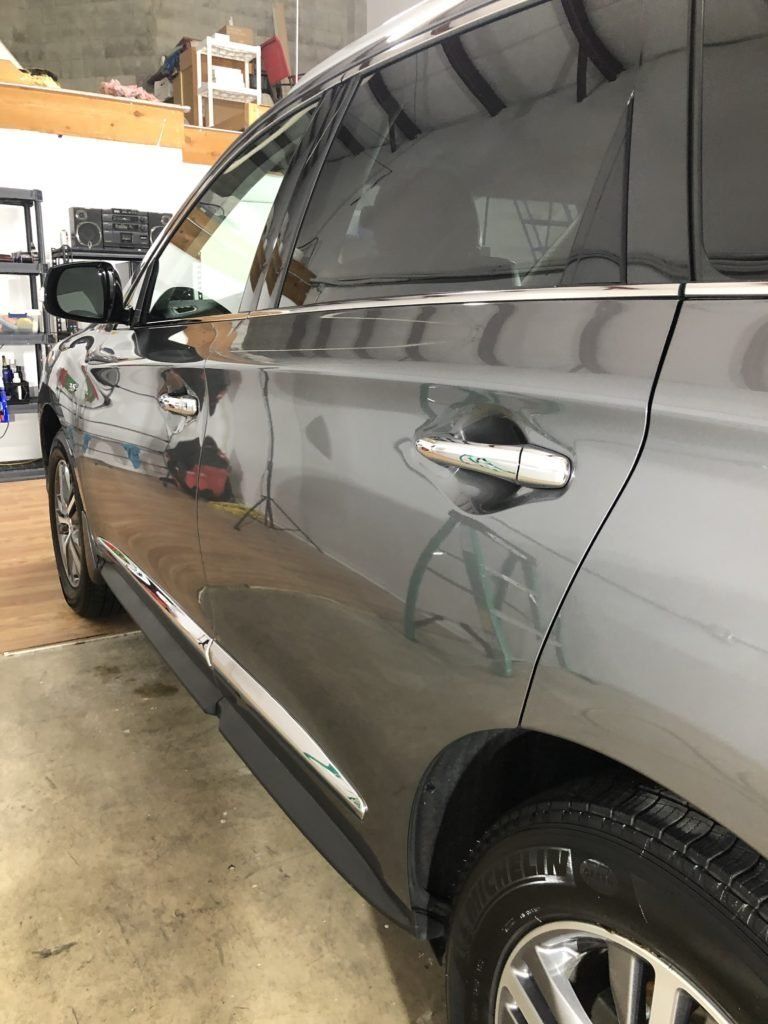 A black suv is parked in a garage.