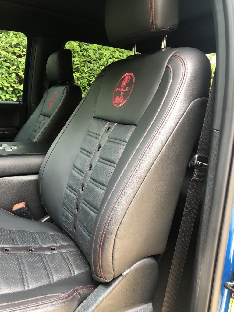 A close up of the seats in a blue truck.
