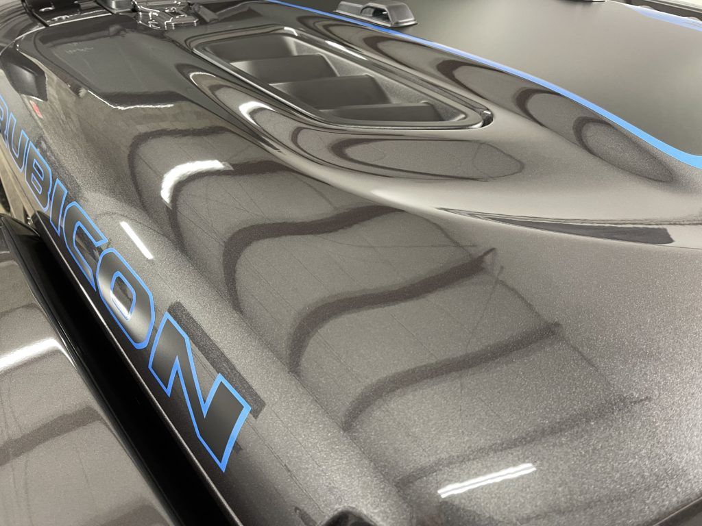 A close up of the hood of a car with the word jeep on it
