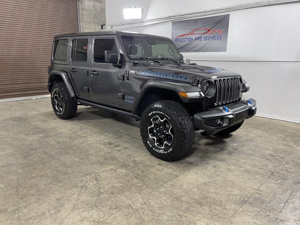 A jeep wrangler is parked in a garage.