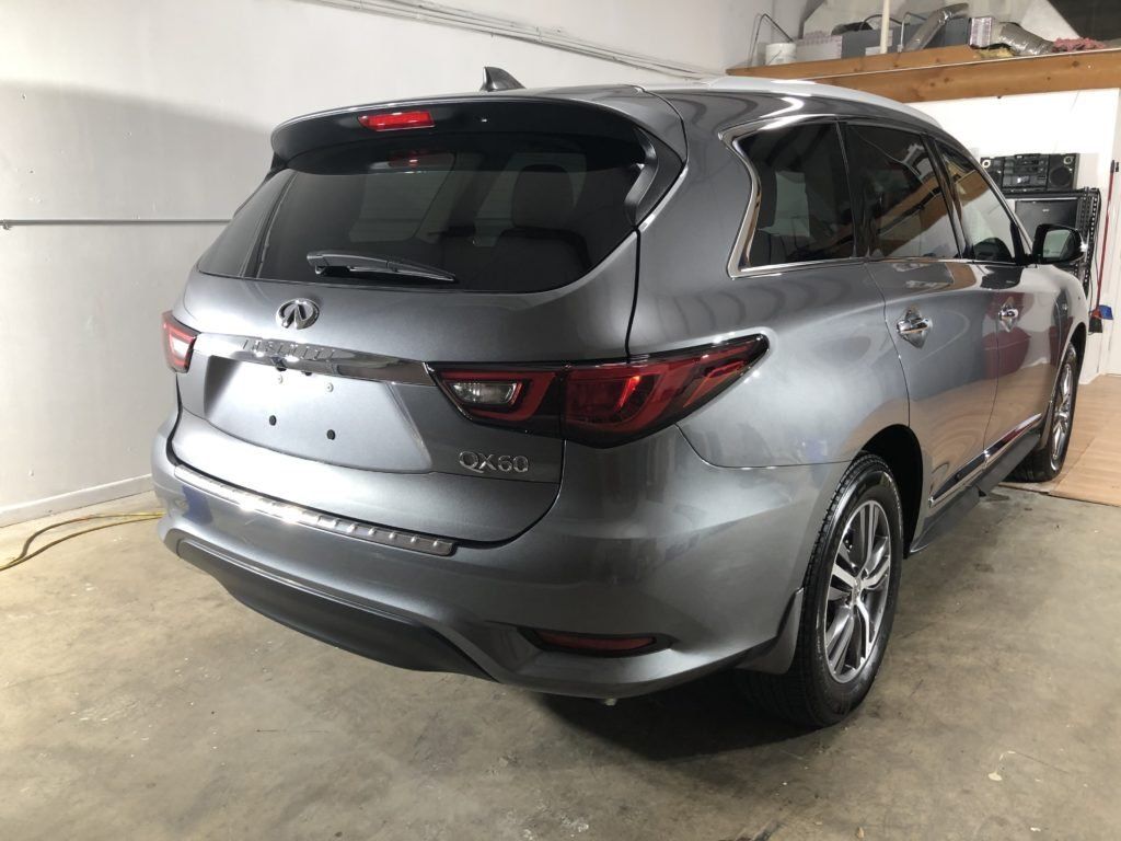 A gray suv is parked in a garage.