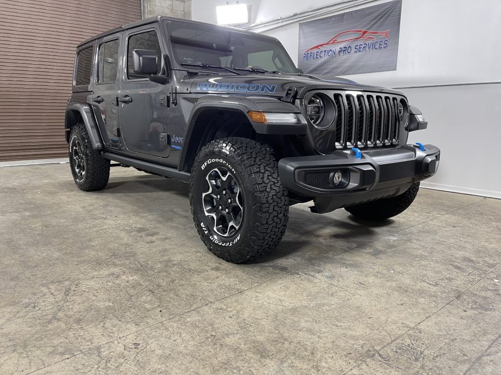 A jeep wrangler is parked in a garage.