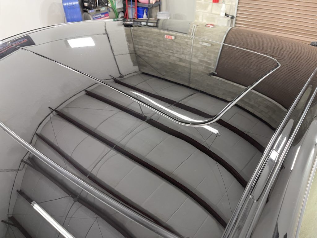 A close up of a car windshield in a garage.