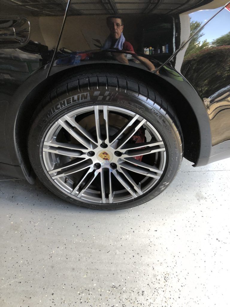 A close up of a car wheel in a garage.