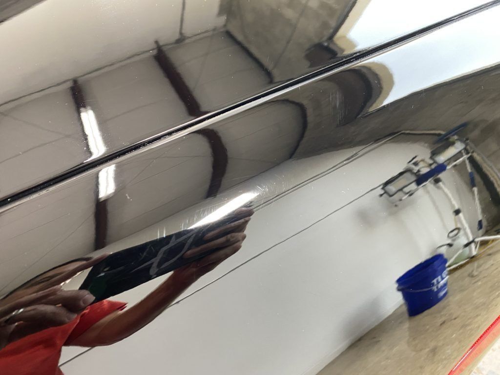 A person is standing in front of a mirror looking at their reflection