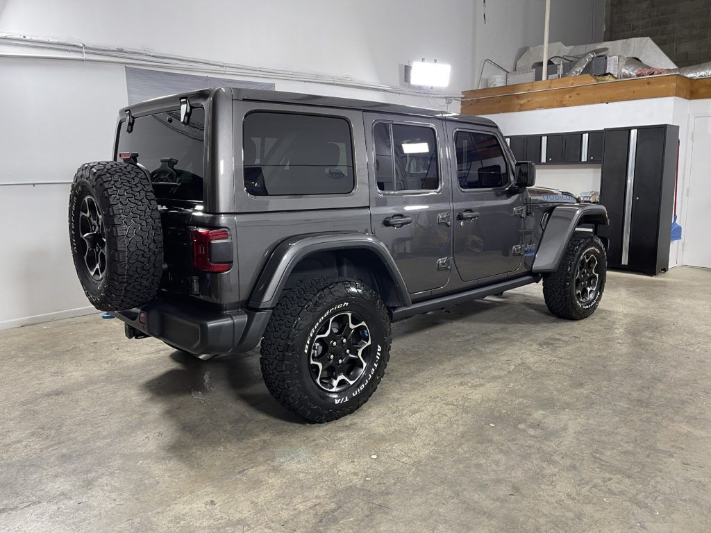 A jeep wrangler is parked in a garage.