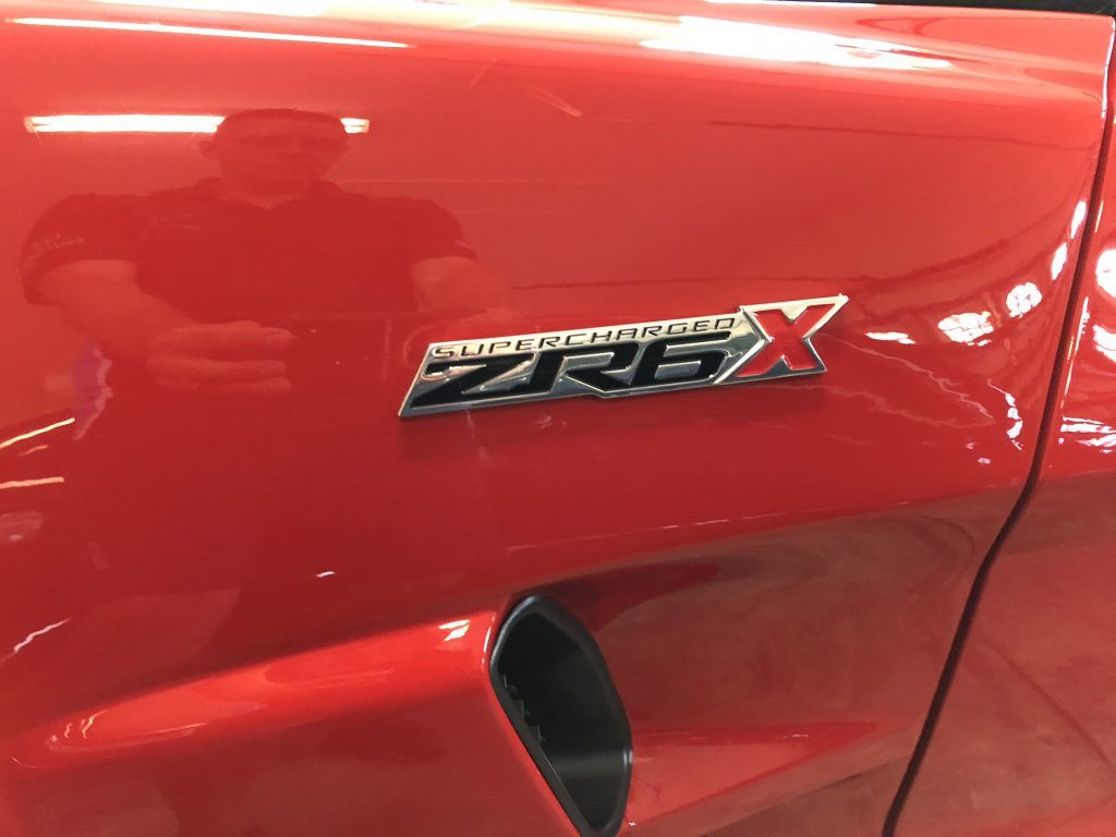 A red car with a zrex emblem on the side