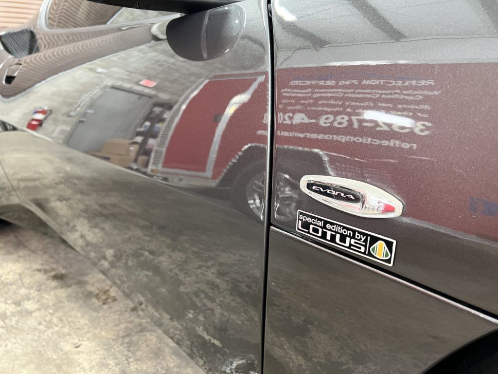 A car with a sticker on the side that says lotus