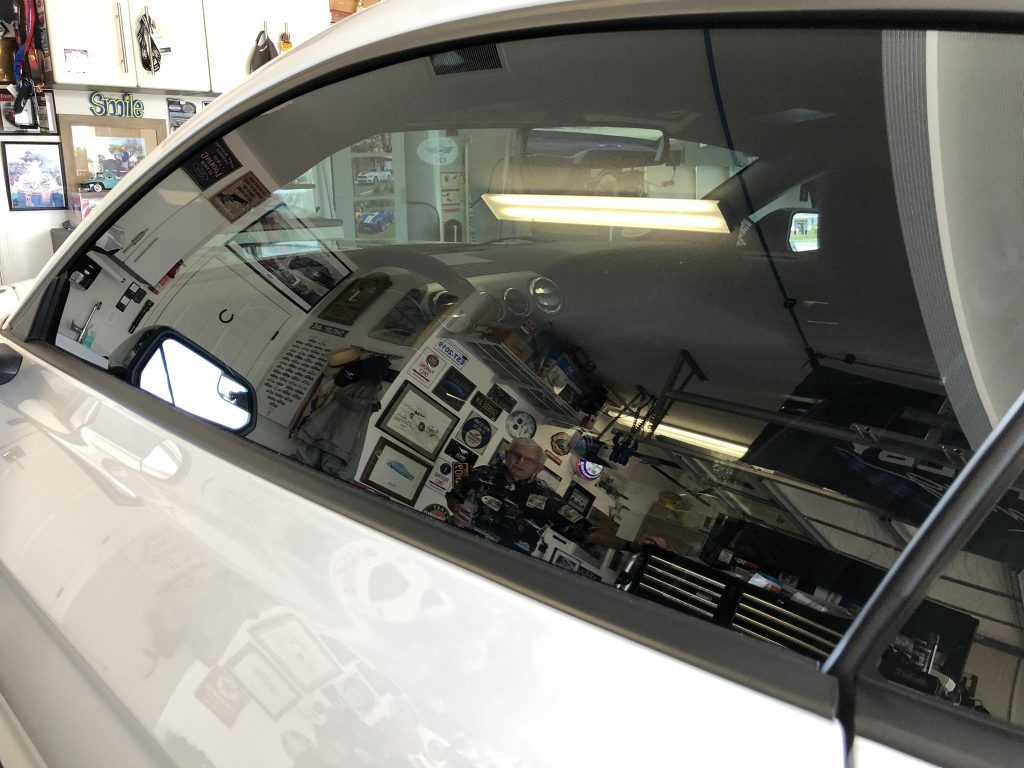 The inside of a car is reflected in the window.