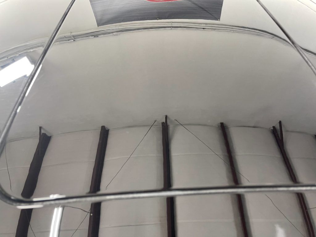 A ceiling with a reflection of a person in it
