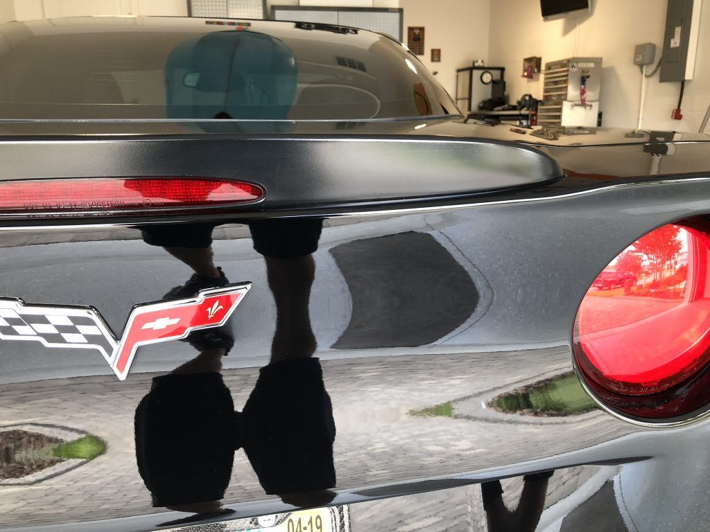 A black car with a red checkered flag on it
