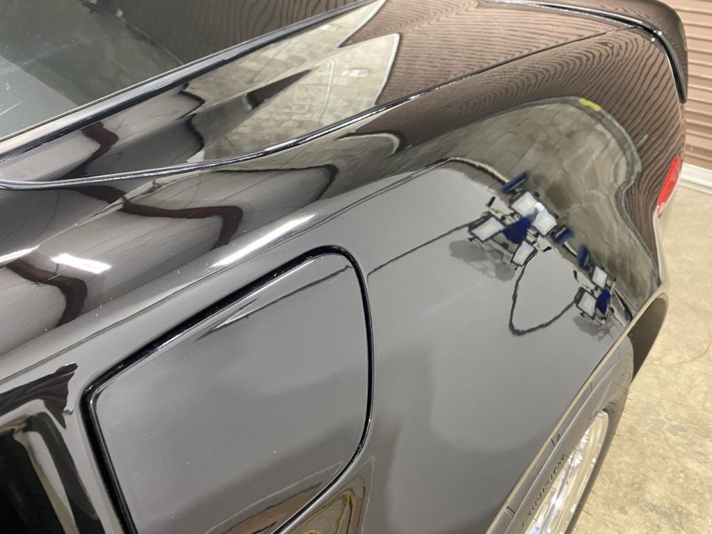 A close up of a car 's fender and trunk.
