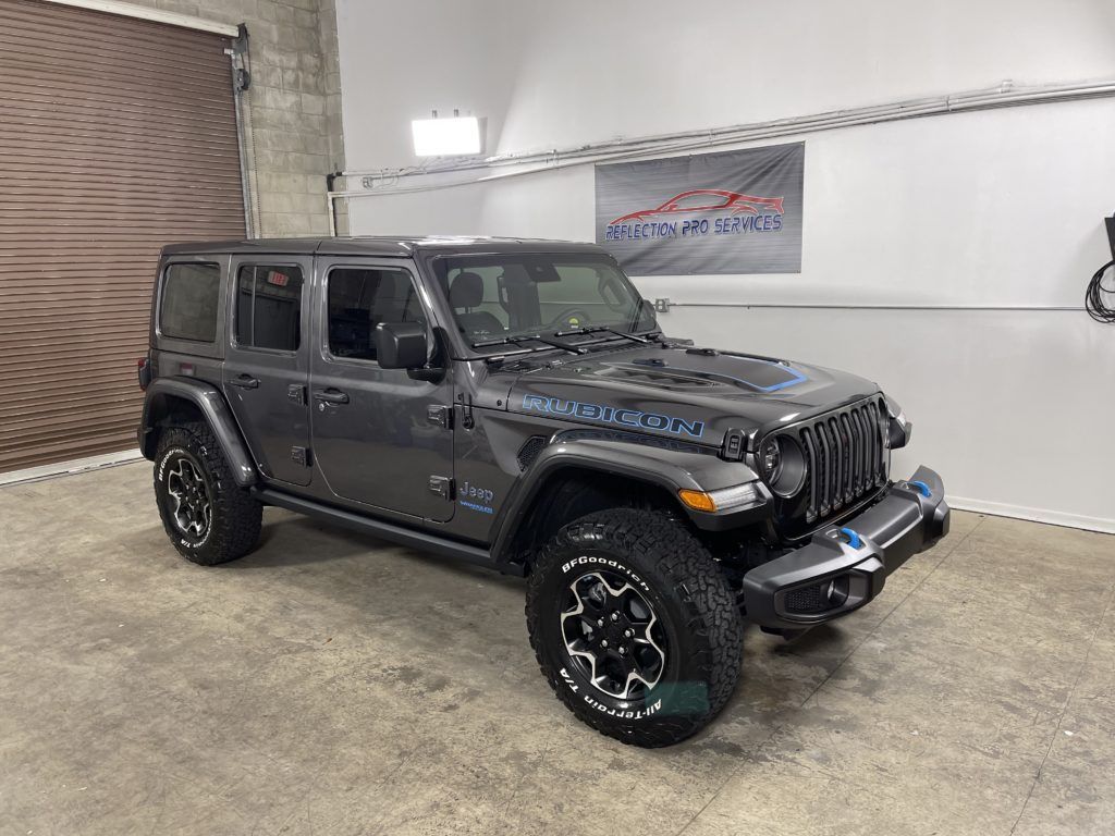 A jeep wrangler is parked in a garage.