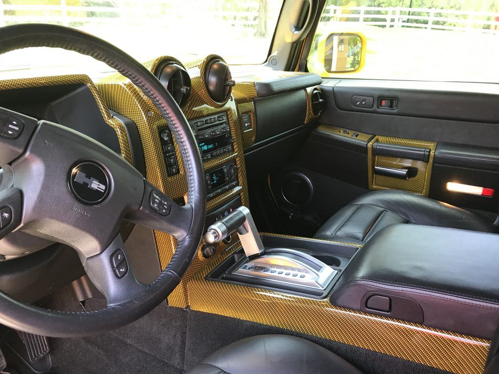 The interior of a hummer h2 with a steering wheel