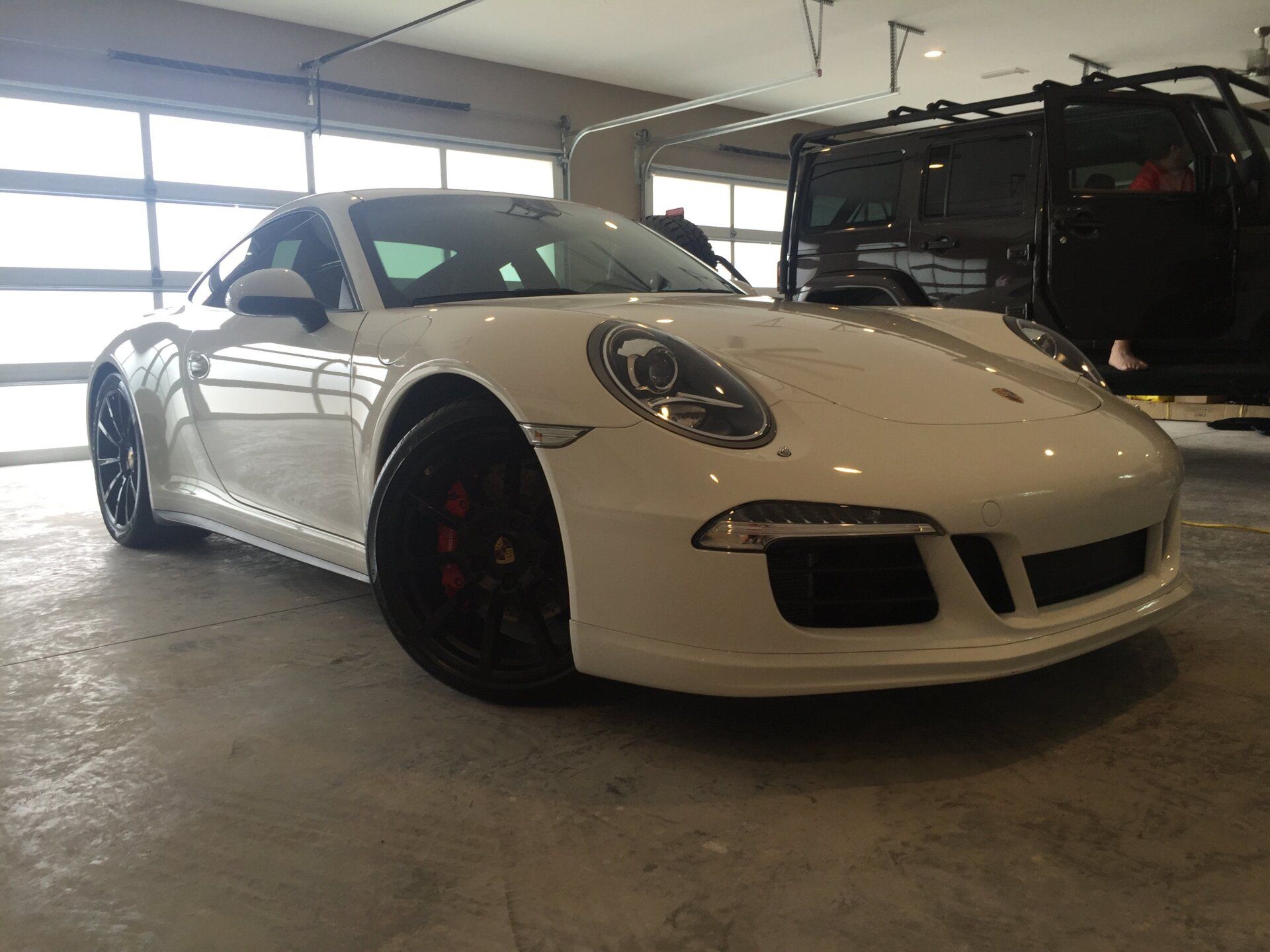 A white porsche 911 gt3 is parked in a garage