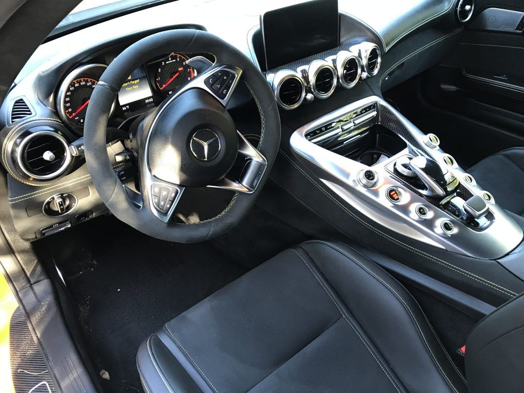The interior of a mercedes benz sports car with a steering wheel and dashboard.