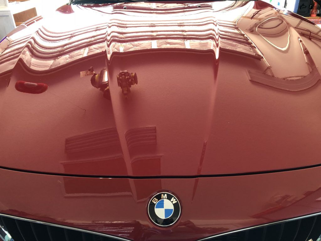 A close up of the hood of a red bmw