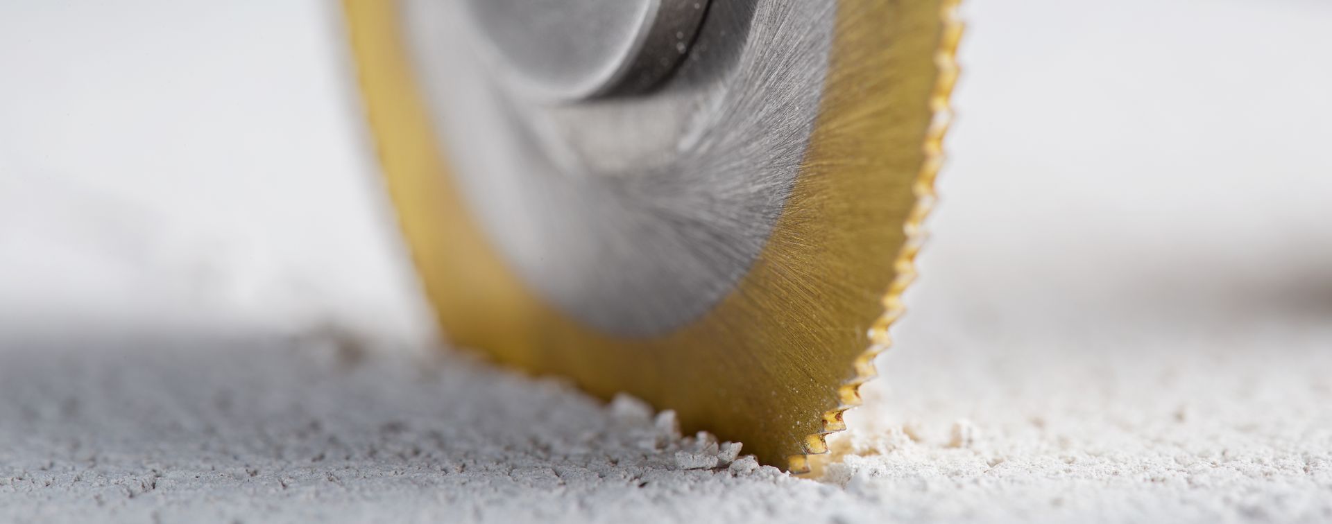 Metal drill bit making a concrete hole, showcasing expert concrete drilling services in action.