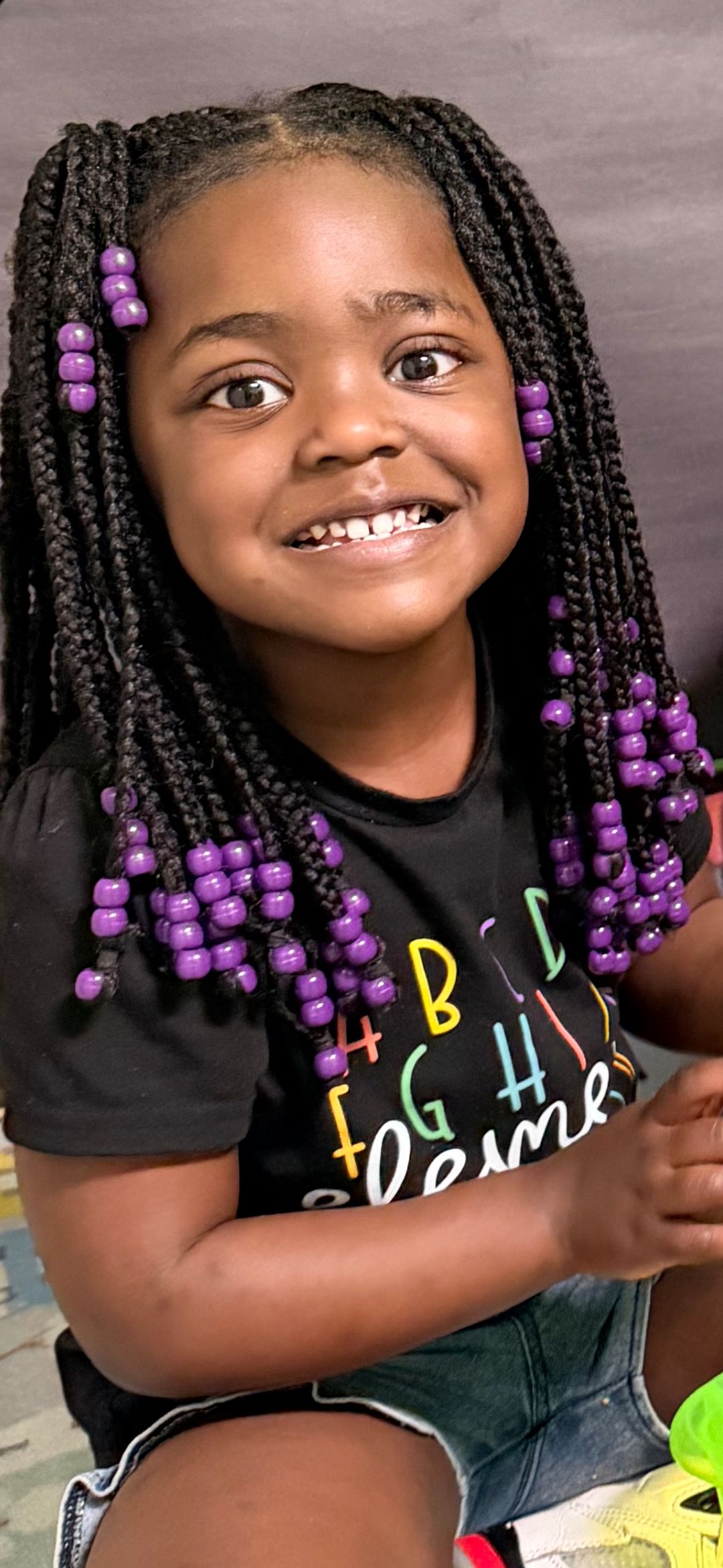 Young girl smiling and wearing a black t-shirt.