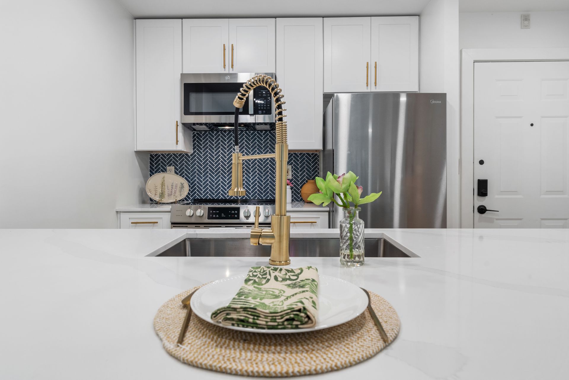 Decorative place setting on the quartz countertop in a model home's kitchen at Clairmont Crest senior living apartments in Decatur, GA.