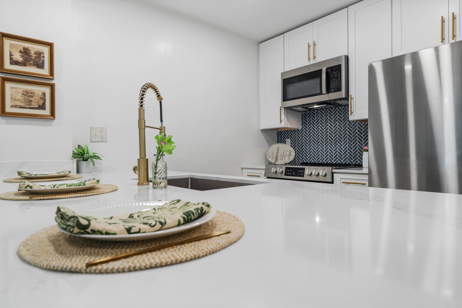 Modern kitchen with smooth quartz countertop in a model home at Clairmont Crest senior living apartments in Decatur, GA.