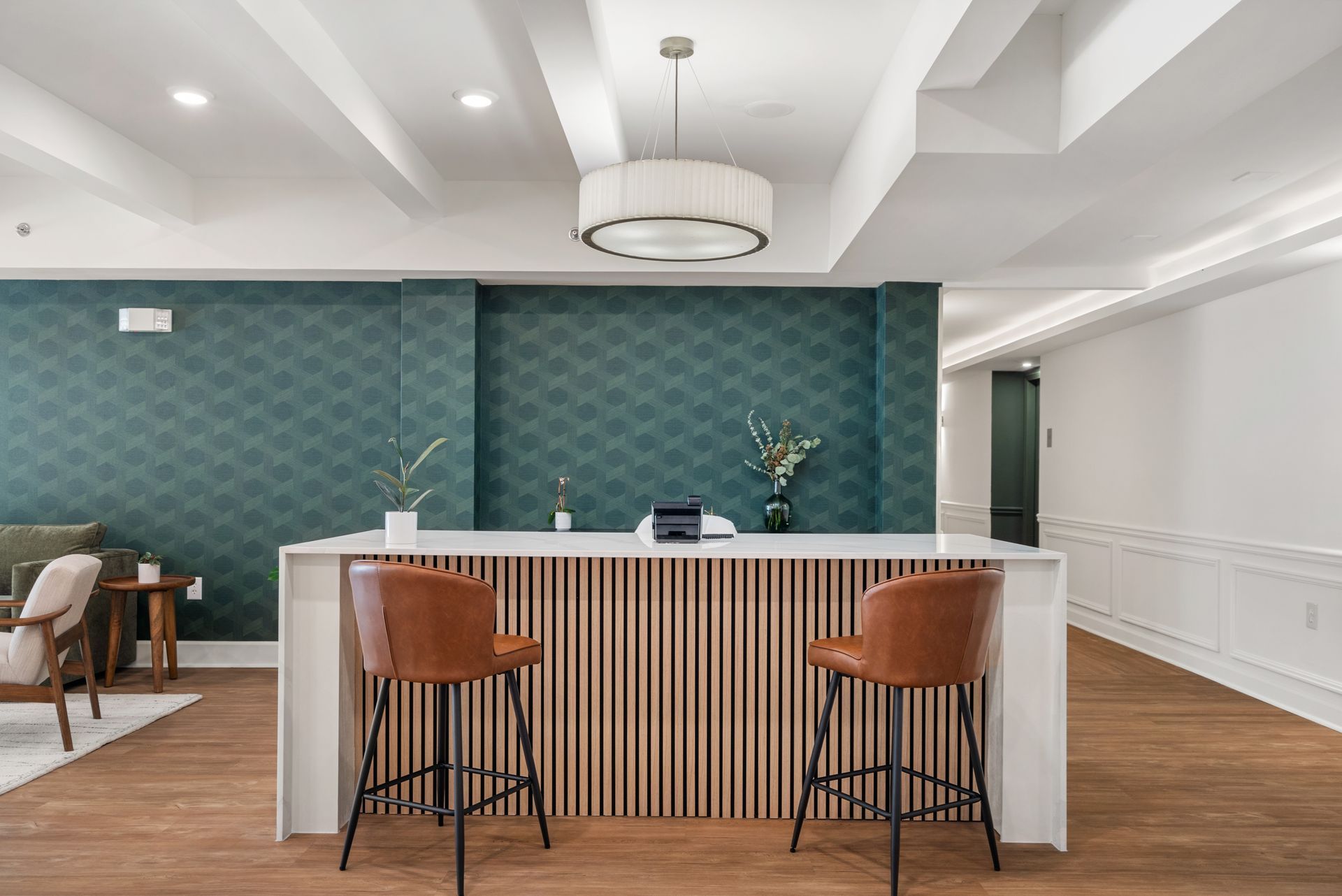 Bar seating at a lobby desk area at Clairmont Crest senior living apartments in Decatur, GA.