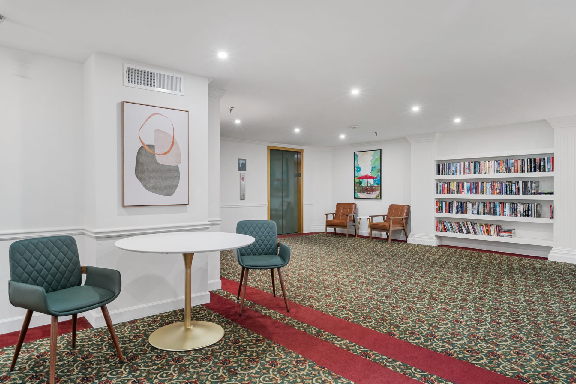 Seating area in the library at Clairmont Crest senior living apartments in Decatur, GA.