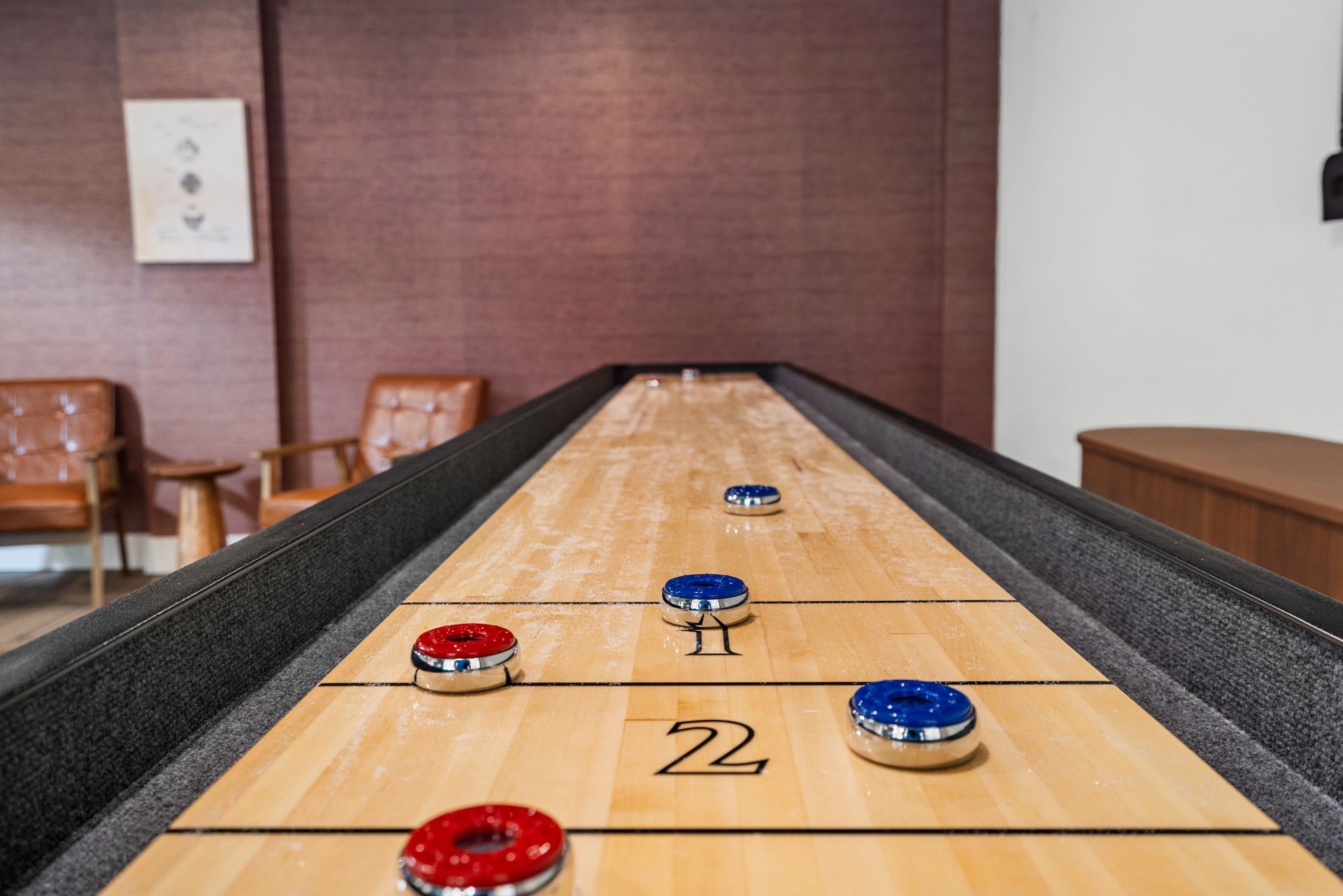 Closeup of tabletop shuffleboard at Clairmont Crest senior living apartments in Decatur, GA.