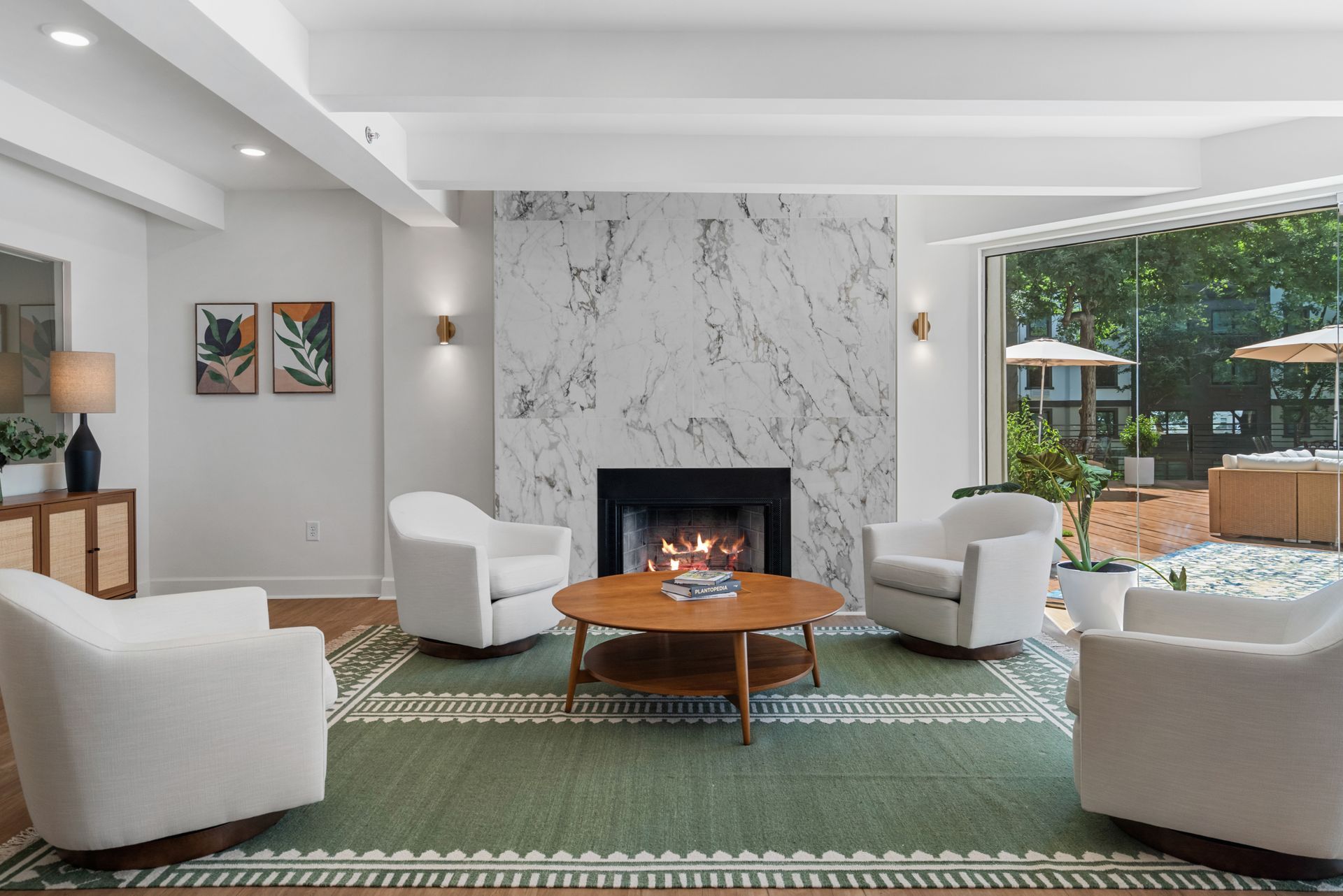 Lounge area in front of a fireplace in the lobby at Clairmont Crest senior living apartments in Decatur, GA.