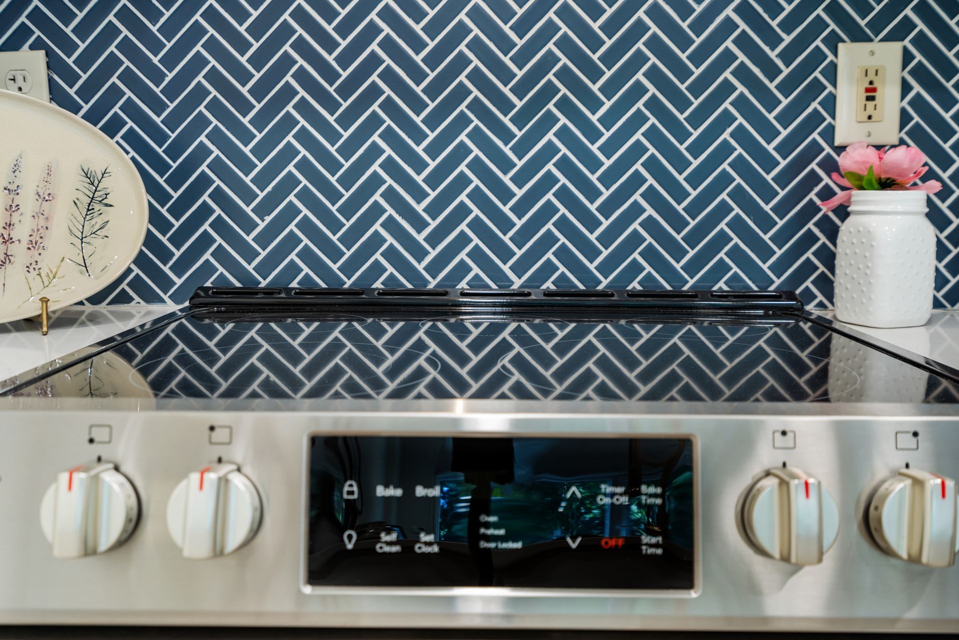 Modern range with elegant tile backsplash in a model home's kitchen at Clairmont Crest senior living apartments in Decatur, GA.