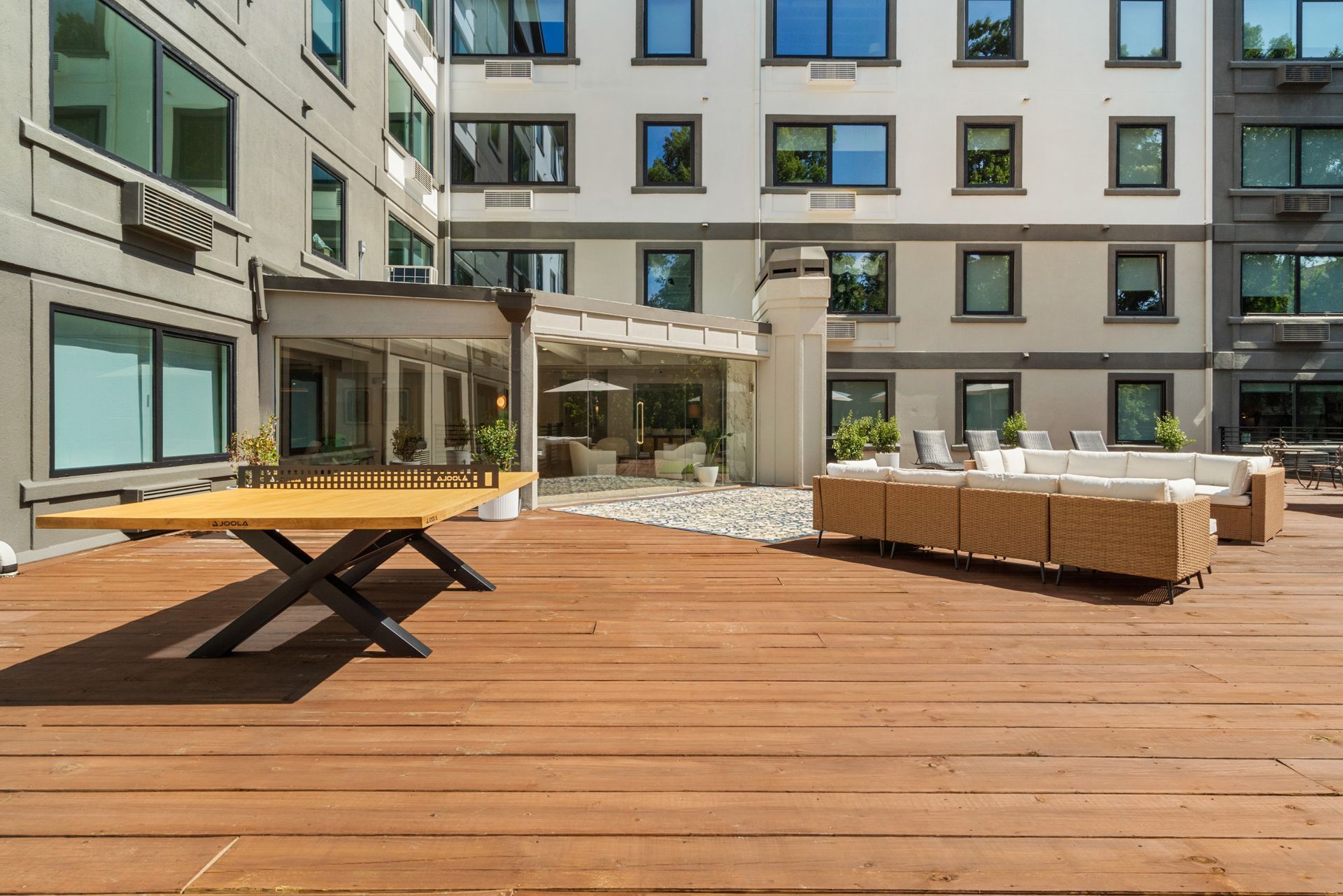Wooden table tennis at the deck lounge outside at Clairmont Crest senior living apartments in Decatur, GA.