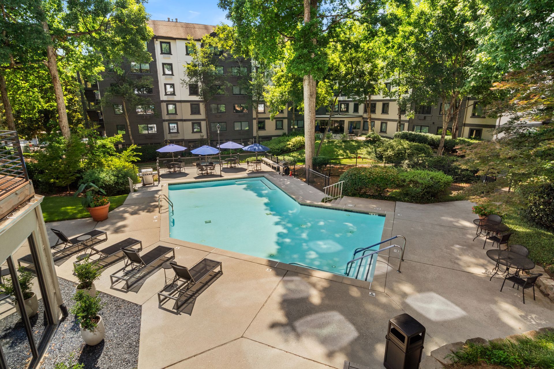 Plenty of shade near the pool at Clairmont Crest senior living apartments in Decatur, GA.