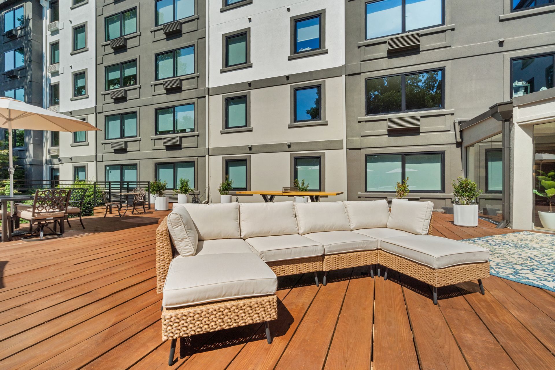 Comfortable sectional couch at the deck lounge area at Clairmont Crest senior living apartments in Decatur, GA.
