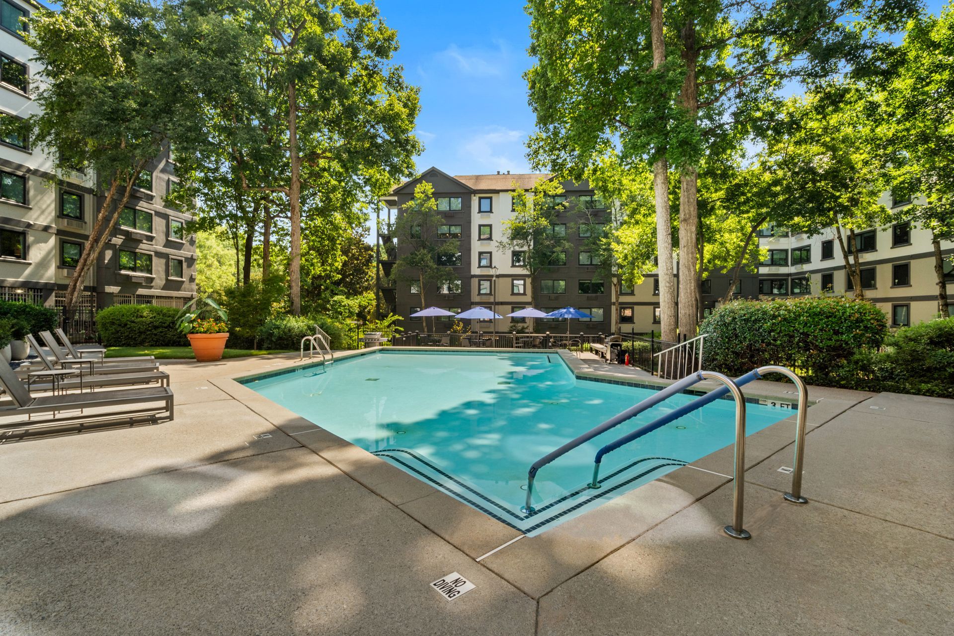 Handrails leading down steps into the swimming pool at Clairmont Crest senior living apartments in Decatur, GA.