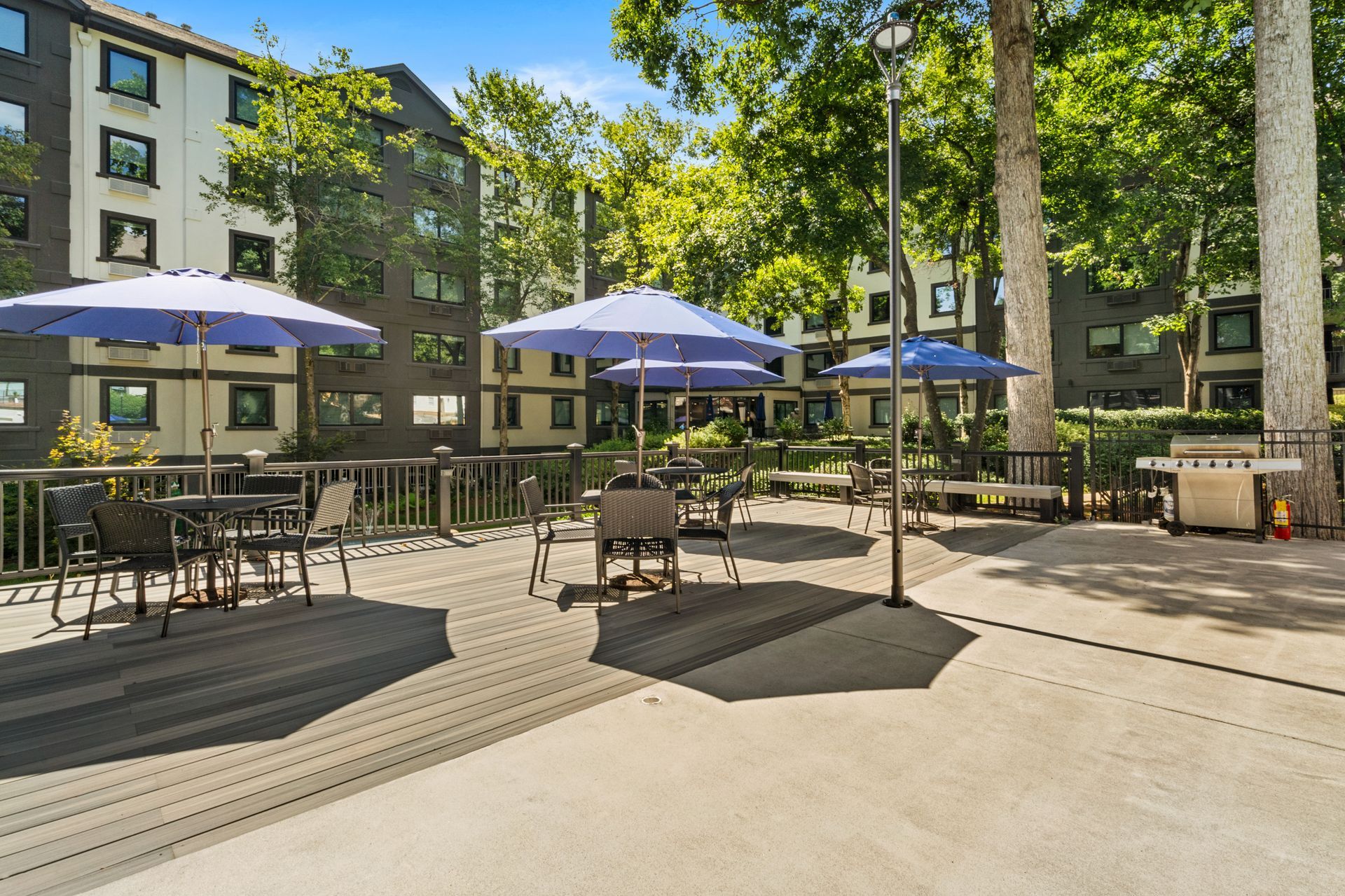 Shaded seating near the pool at Clairmont Crest senior living apartments in Decatur, GA.