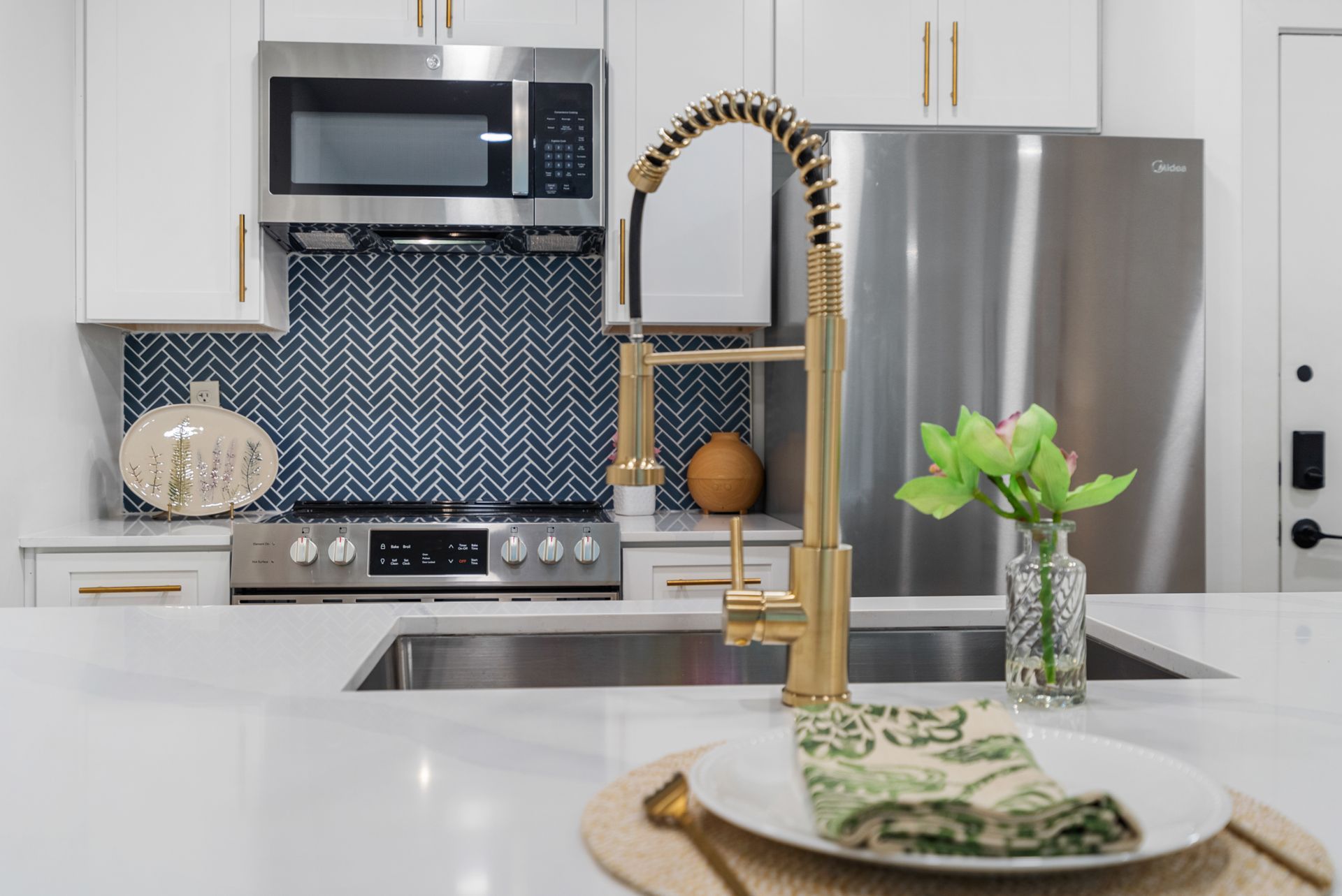 Gooseneck faucet and dual-basin sink in a model home's kitchen at Clairmont Crest senior living apartments in Decatur, GA.