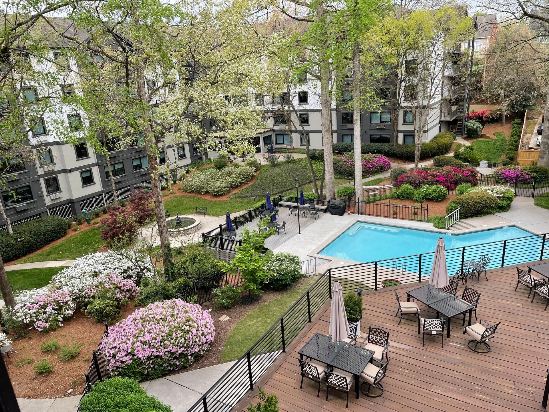 View of the swimming pool area from an upper floor at Clairmont Crest senior living apartments in Decatur, GA.