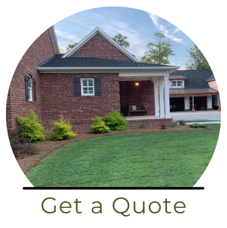A circular image of a red brick house with a covered porch and manicured lawn, featuring the text