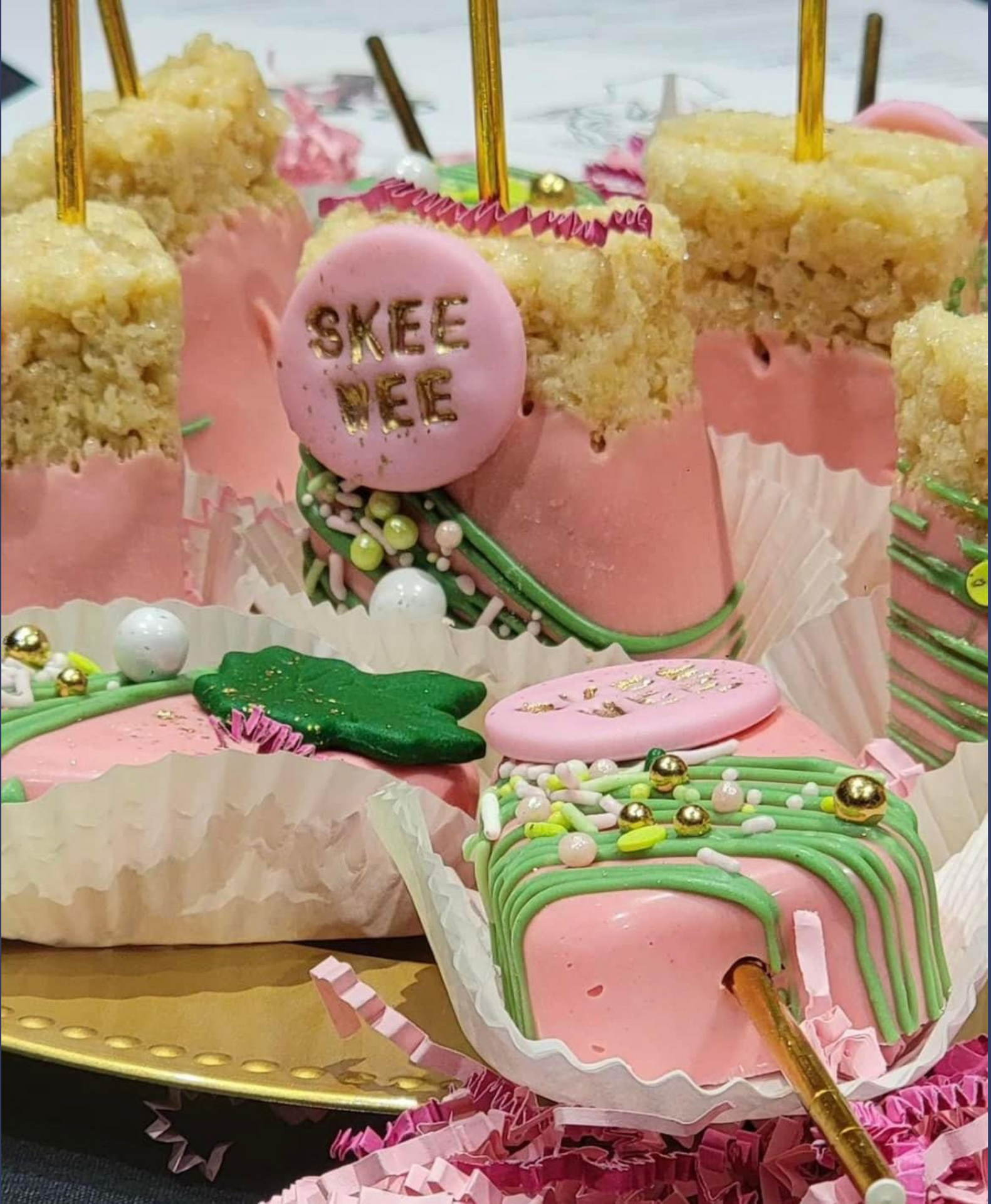 A bunch of pink and green cupcakes on a plate.