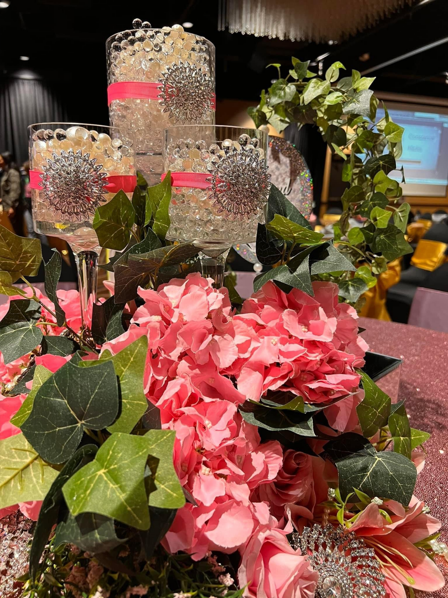 A table is decorated with pink flowers and candles.