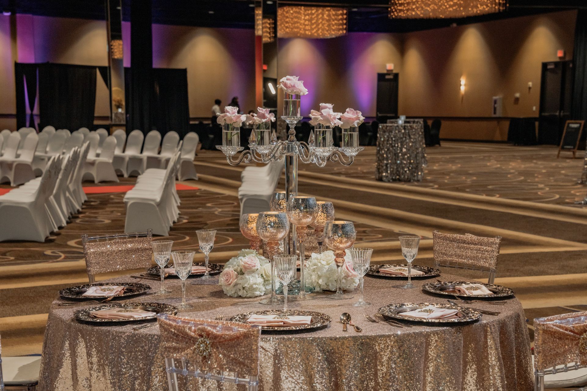 A table set for a wedding reception in a large room.